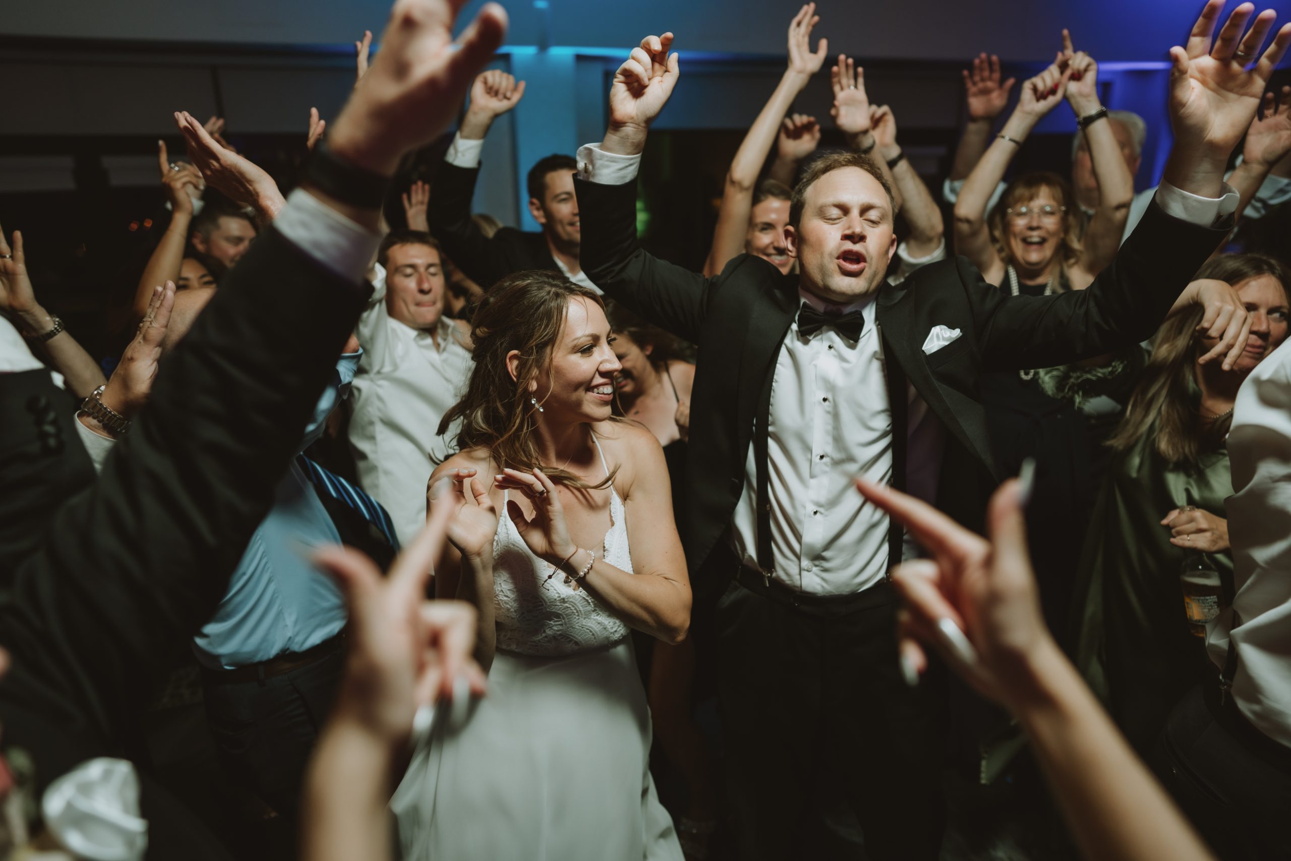 The bride and groom surrounded by their guests on the dancefloor at The Clubhouse at Galloping Hill in Kenilworth, New Jersey