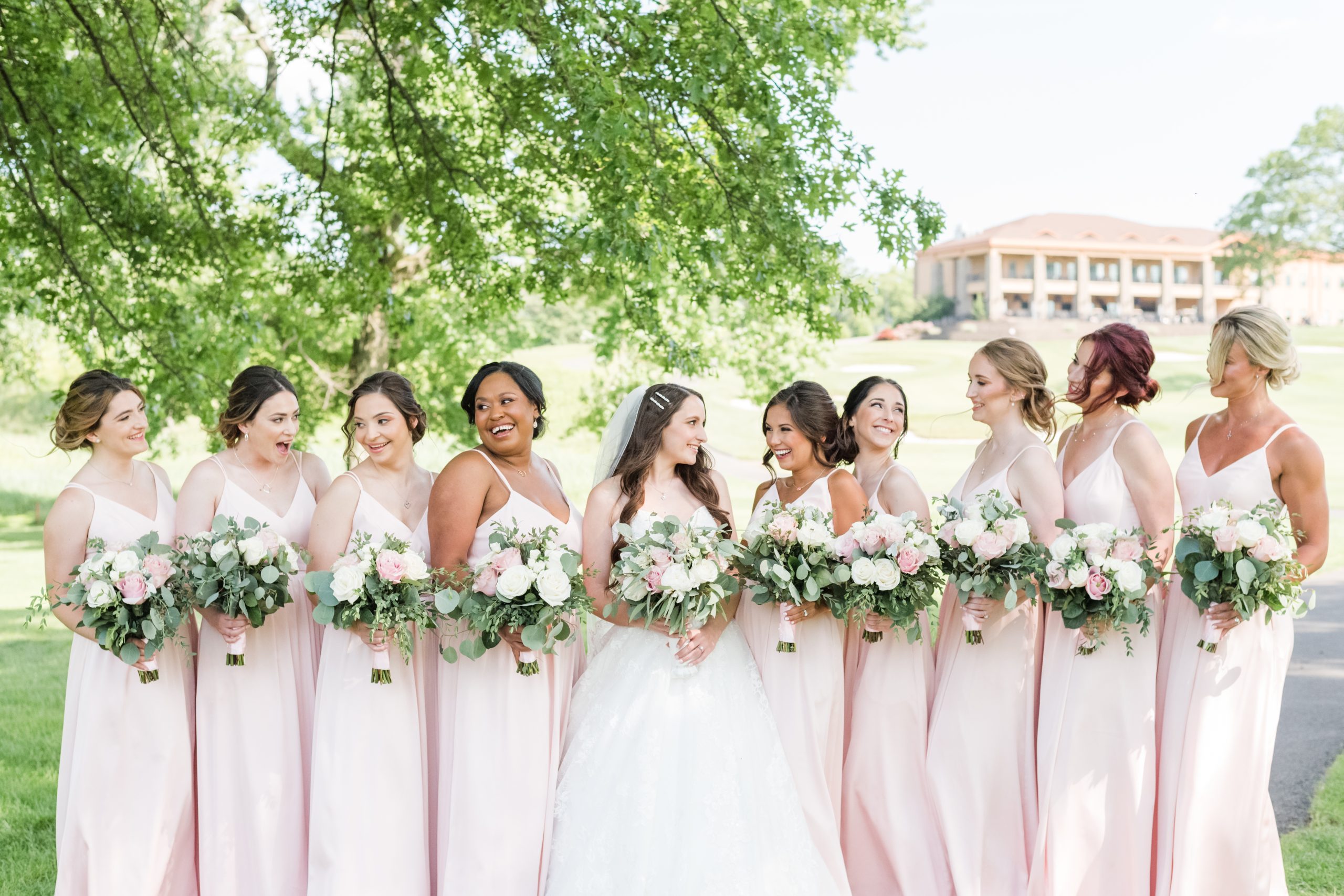 The bride and bridesmaids in front of The Clubhouse at Galloping Hill in Kenilworth, New Jersey