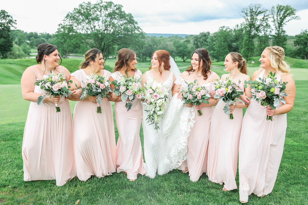 A bride and her bridesmaids on the golf course at The Clubhouse at Galloping Hill in Kenilworth, New Jersey