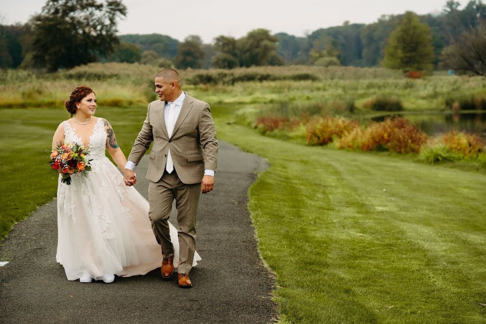 Wedding Couple walking around Experience a Fall Wedding at The Clubhouse at Galloping Hill during the Fall